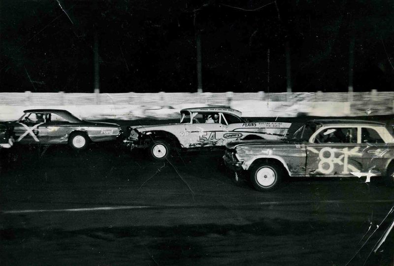 Joe Putman in '57 Chevy with Danny Everett on the inside, unknown driver on the outside. Lubbock's Arena Park Raceways.